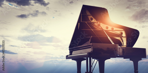 Fototapeta Grand piano on sunset sky background