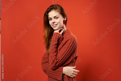 red-haired woman in red sweater jewelry earrings fashion