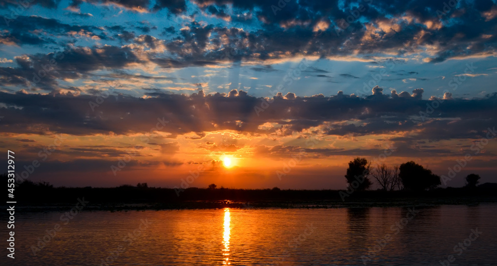 Fototapeta premium sunrise over the river in summer from the clouds