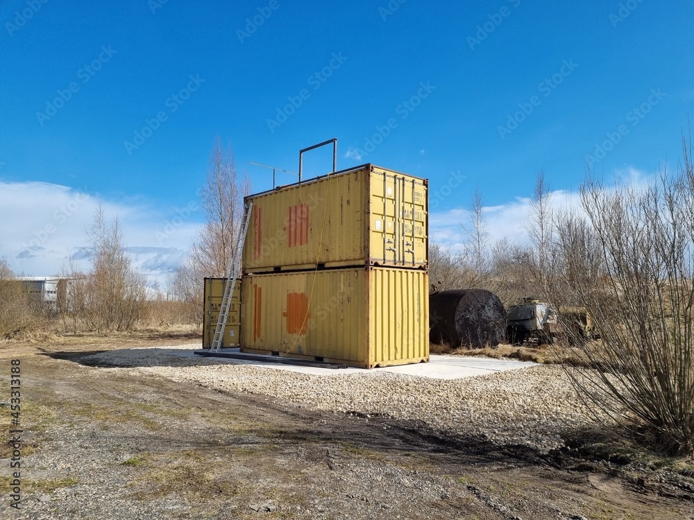 Containers in the field. Welder during work Containers in the field. Welder during work