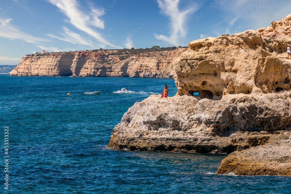 Women watching the sea in the beautiful coastal area of Carvoeiro - Algarve, Portugal