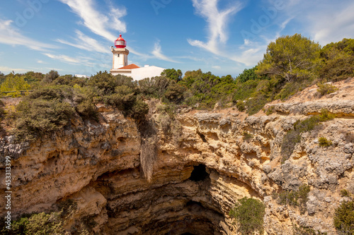 Beautiful Alfanzina Lighthouse in the coastal area of Carvoeiro, Algarve - Portugal