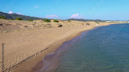 4k aerial drone footage of Chalikounas beach on a land strip between Lake Korission and Ionian Sea on Corfu Island in Greece photo