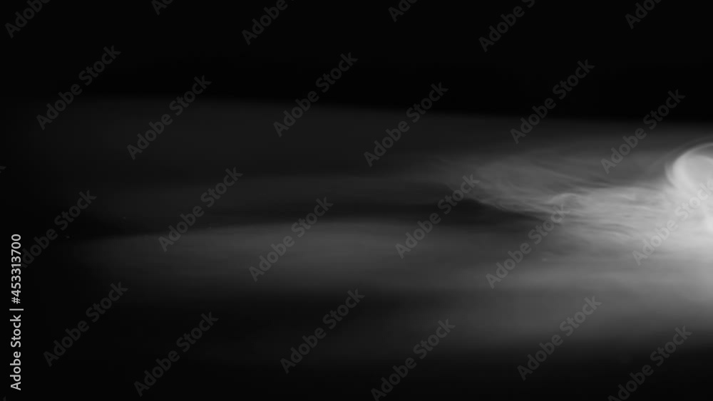 Waves of White Fog. Heavy white smoke slowly spreads over the black surface gradually dissolving Waves of White Fog. Heavy white smoke slowly spreads over the black surface gradually dissolving