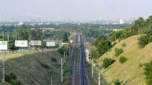 View of the industrial city of Zaporozhye, Ukraine. Smog emissions, air pollution. Bad environmental situation. Metallurgical plants. Railway photo