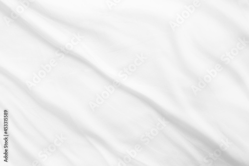 Crumpled white cotton fabric sheet texture. Morning bed. Minimalistic blank mock up background.