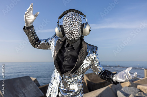 Mr disco man with sparkly face and headphones