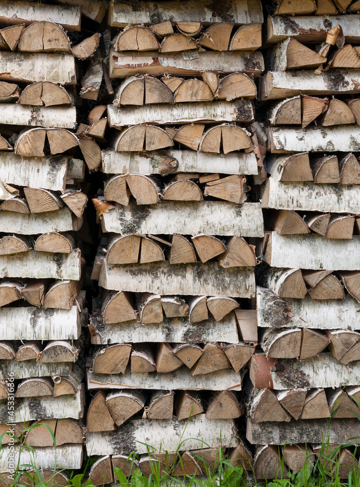 Birch firewood stacked in rows front view Birch firewood stacked in rows front view