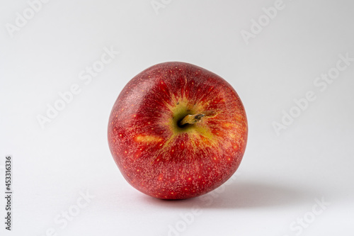A red apple "Royal gala" against a white background. Food product photography, healthy food