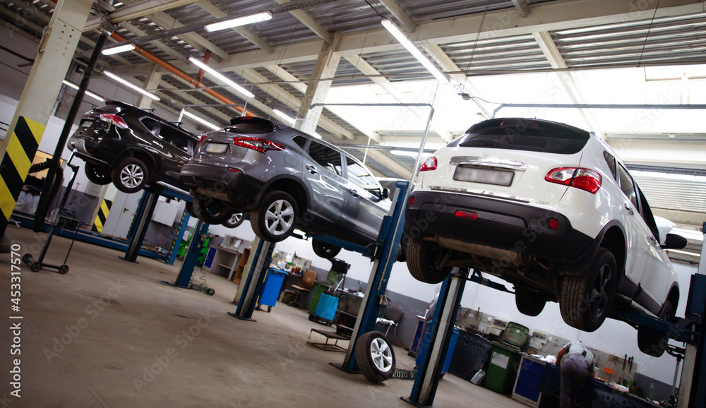 Modern car repair station with a large number of lifts and specialized equipment for diagnostics and service repair car Modern car repair station with a large number of lifts and specialized equipment for diagnostics and service repair car