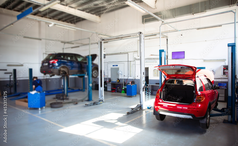 Modern car repair station with a large number of lifts and specialized equipment for diagnostics and service repair car Modern car repair station with a large number of lifts and specialized equipment for diagnostics and service repair car