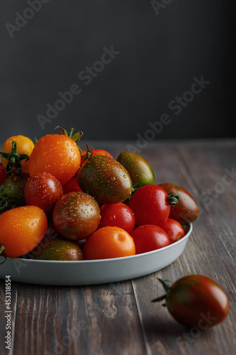 Cherry tomato - assorted multicolored tomatoes on table, space for text