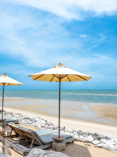 Seascape view and sunlight under cloudy blue sky with umbrella