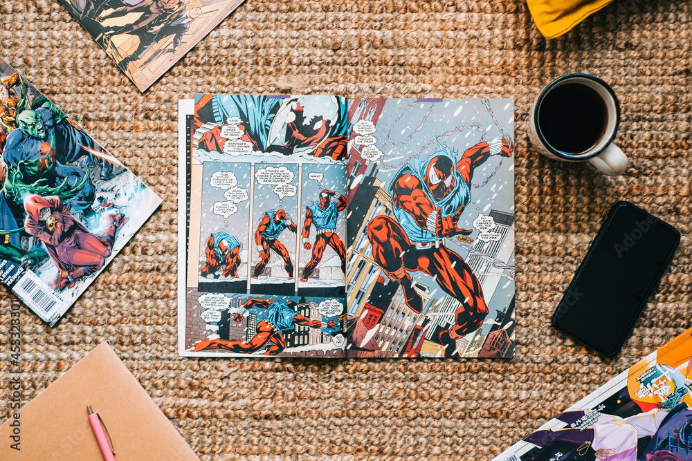 Naklejka premium Reading comic books and manga on the carpet at cozy home. Rostov-on-Don, Russia. 22 August 2021