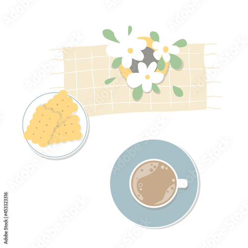 A cup of coffee with a cookies and flowers. Top view on the table. Cozy breakfast.