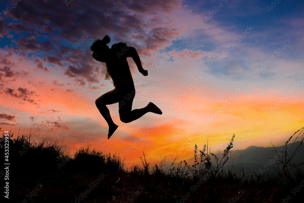 custom made wallpaper toronto digitalSilhouettes of men jumping with joy and freedom In the meadow during the evening time. man jump high and step on the sun in the silhouette.