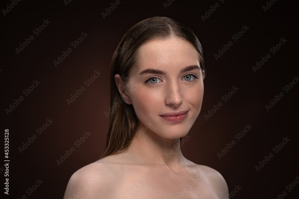 Headshot portrait of happy girl with natural make up and bare shoulders. Healthy pure skin model isolated on black background. Natural make up concept. Spa and beautiful concept. Headshot portrait of happy girl with natural make up and bare shoulders. Healthy pure skin model isolated on black background. Natural make up concept. Spa and beautiful concept.