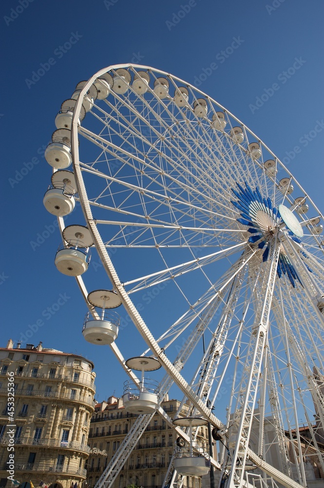 white big wheel in the Marseille harbour with blue sly