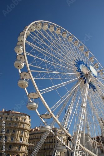 white big wheel in the Marseille harbour with blue sly