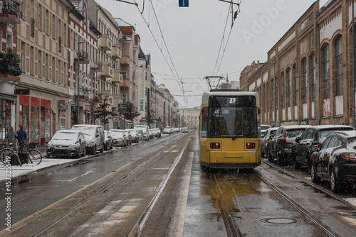 Tram in Berlin Schöneweide in winter, a street in wintry Berlin, snowfall