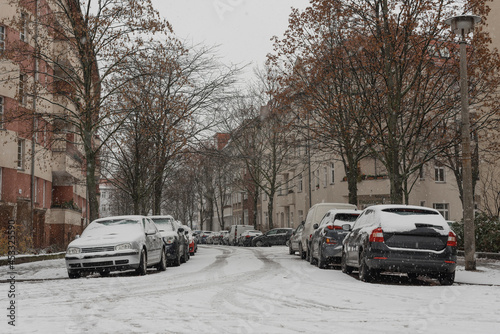 Canvas Print Parked cars in winter, cars covered with snow, snow-covered small street in Berl