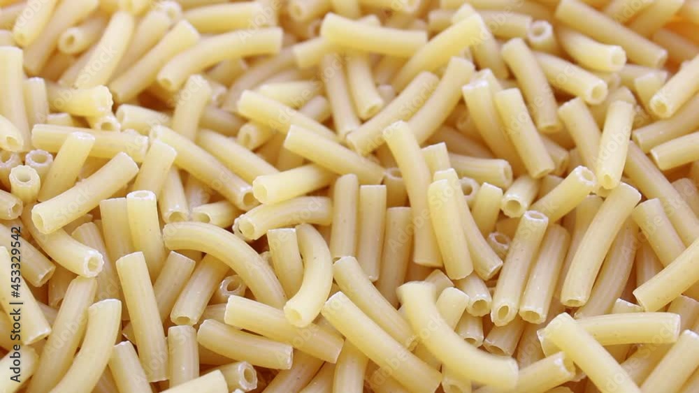 Stack of uncooked pasta, close up view of raw food Stack of uncooked pasta, close up view of raw food
