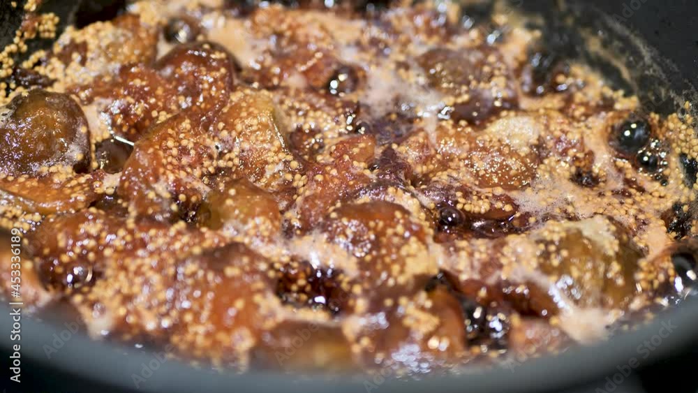 Preservation of fruit. Fig jam. Figs are boiled in syrup. Foam bubbling in the pan. Slow motion. Scene B. Preservation of fruit. Fig jam. Figs are boiled in syrup. Foam bubbling in the pan. Slow motion. Scene B.