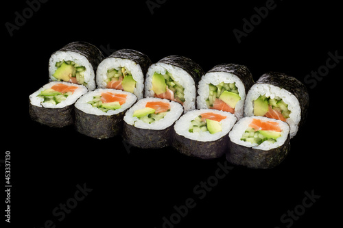 Japanese food: maki and nigiri sushi set on black background. side view composition.