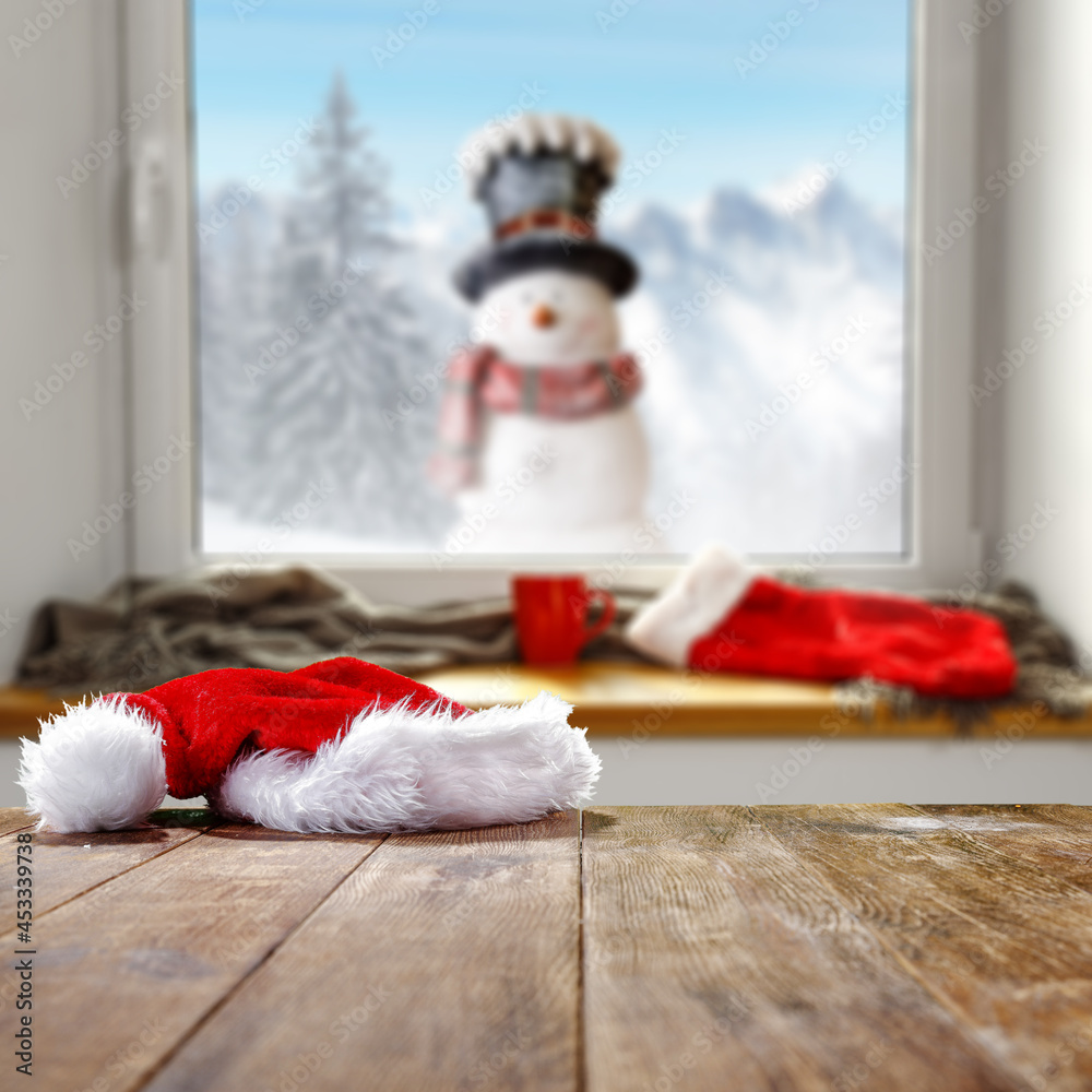 Obraz premium Winter window background and wooden desk of free space for your decoration 