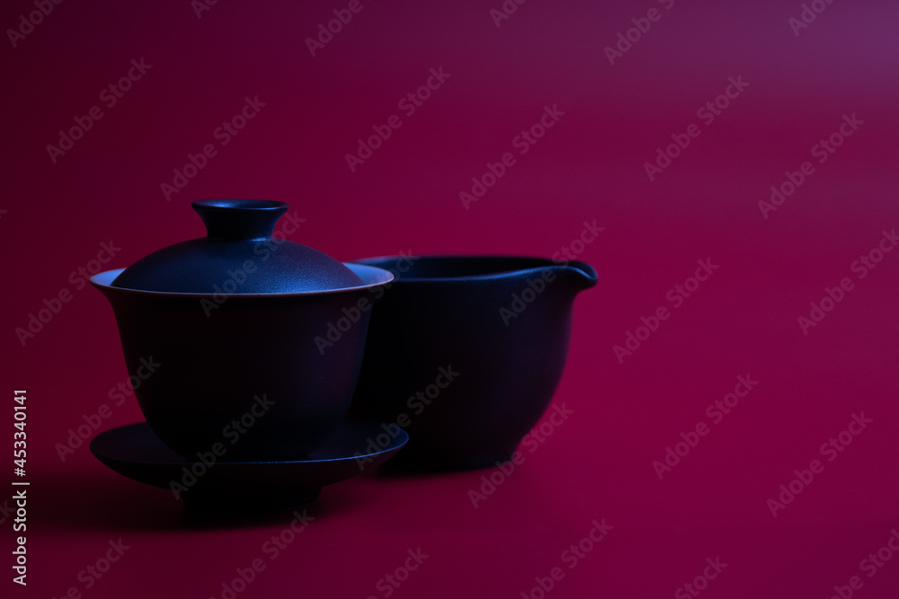 Black Chinese Tea Cup on Red Background Black Chinese Tea Cup on Red Background