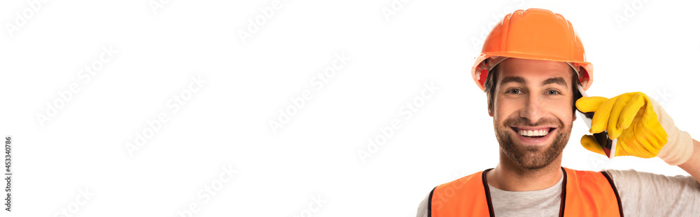 Smiling builder talking on mobile phone isolated on white, banner Smiling builder talking on mobile phone isolated on white, banner