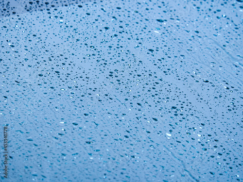 Rainwater wets the windshield. Selective focus image.