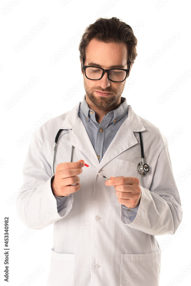 Doctor in eyeglasses holding syringe and cap isolated on white Doctor in eyeglasses holding syringe and cap isolated on white