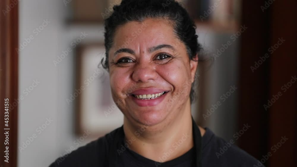 Happy African woman smiling portrait face looking at camera Happy African woman smiling portrait face looking at camera