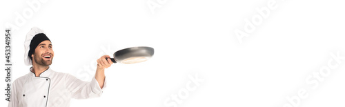 Smiling chef holding blurred frying pan isolated on white, banner