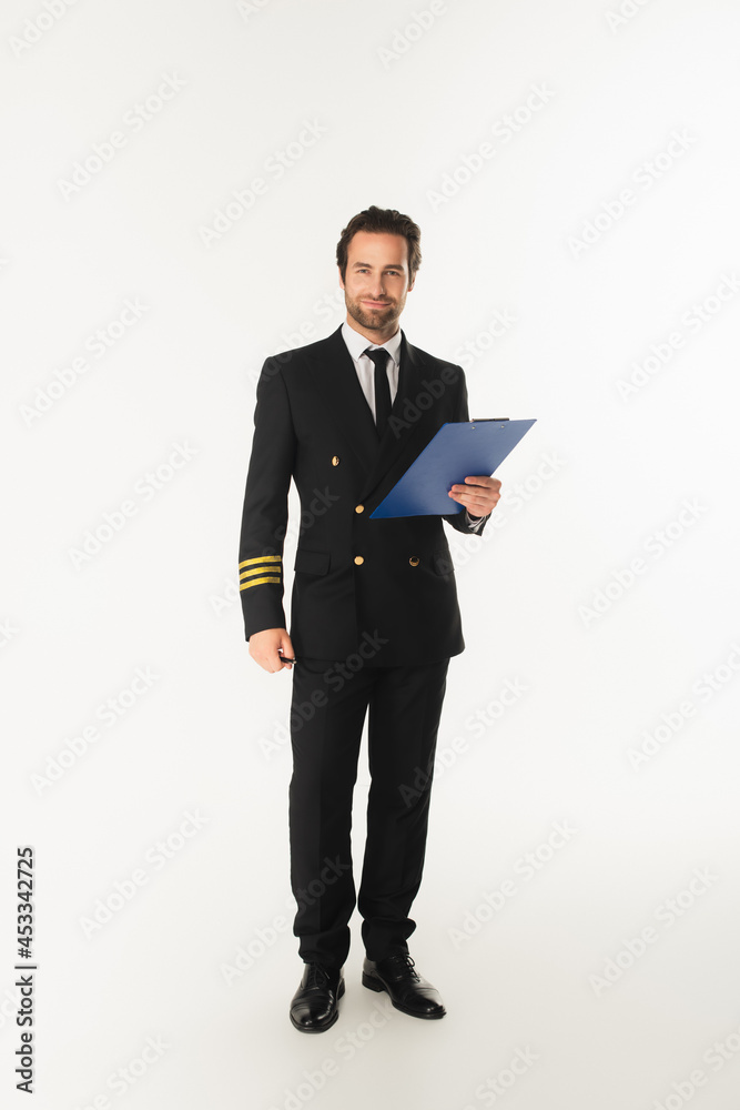 Pilot in uniform holding clipboard on white background Pilot in uniform holding clipboard on white background