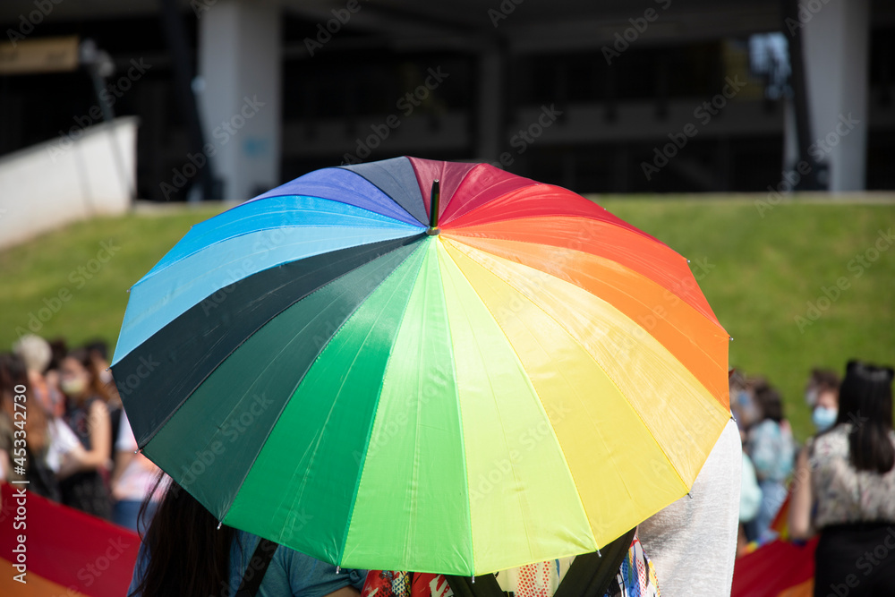 Rainbow flag umbrella at pride parade. Lgbtq concept