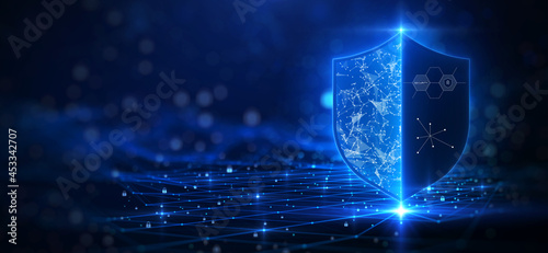 Cybersecurity technology privacy concept to protect data. There is a shield on the right hand side. against a dark blue background with glittering lights as the background. photo