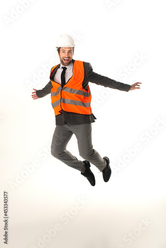 Happy engineer jumping isolated on white
