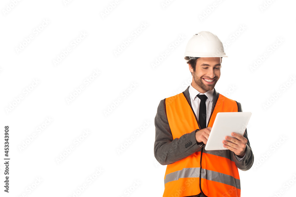 Smiling engineer in safety vest using digital tablet isolated on white Smiling engineer in safety vest using digital tablet isolated on white