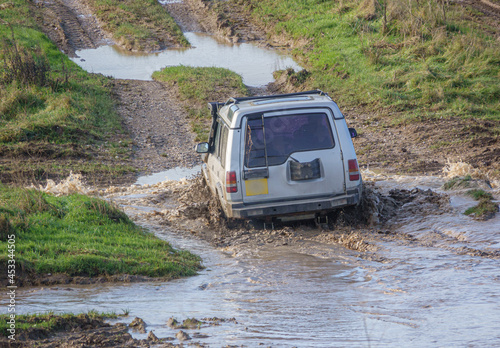 4x4 land rover discovery series II off roading, wading in deep water and slippery mud © Martin