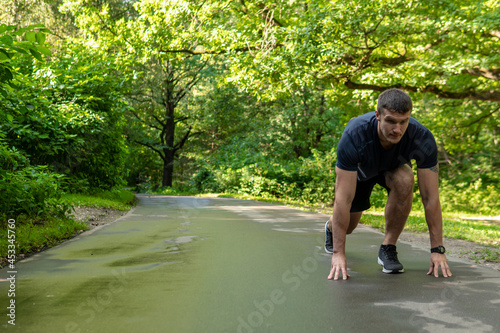 A man athlete runs in the park outdoors, around the forest, oak trees green grass young enduring athletic athlete healthy sport forest, fitness young wellness marathon, park outside. Adult leisure