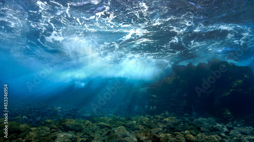 Rays of sunlight over the reef underwater