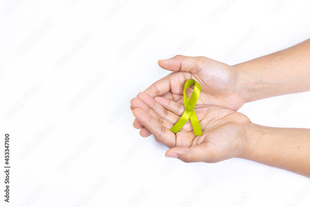two hands holding green ribbon cane, cancer lymphoma, white background two hands holding green ribbon cane, cancer lymphoma, white background