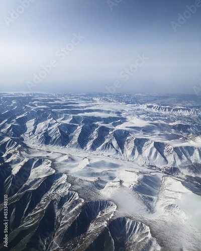 Snow covered mountain range, somewhere over Xinjiang Uygur, China