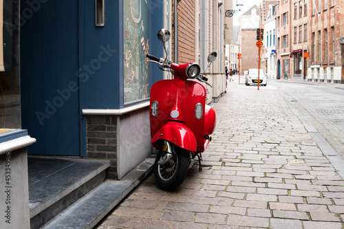 red scooter on a city street