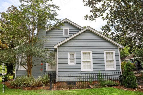 A revently renovated blue small cottage style house