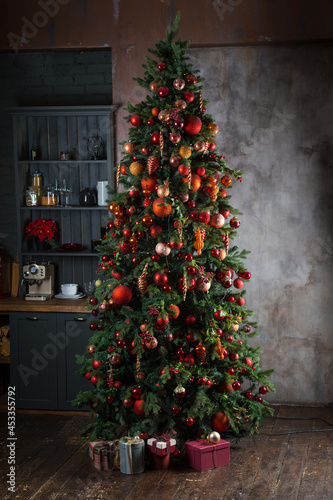 Tall New year tree stands in a kitchen photo