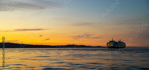 Washington State Ferry Boat cruises through the Puget water during sunset © Mat Hayward