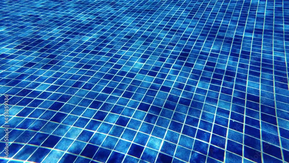 Ripple reflection on a tiled pool bottom. Summer, luxury hotel and spa or vacations concepts Ripple reflection on a tiled pool bottom. Summer, luxury hotel and spa or vacations concepts
